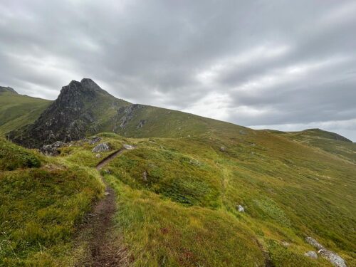 Scenic hiking path across rocky landscape in Lofoten’s Ballstad area.